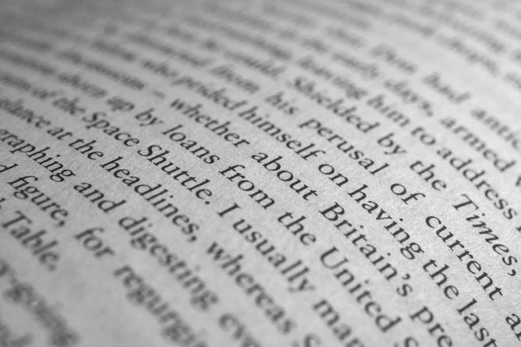 The entire image is words on a page, to resemble how words can be triggering or how they may look to a dyslexic reader