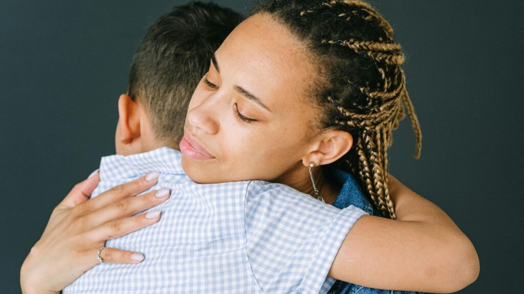 Mother hugging son, to comfort him